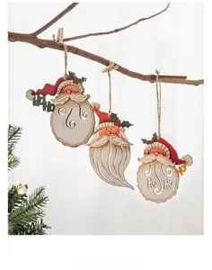 Three wooden Santa Claus ornaments hanging on branches with warm festive lighting