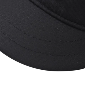 Macro detail of the black fabric brim with reinforced parallel stitching on the sun cap