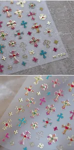 Macro detail of M-794 Baroque style nail stickers with gold embossed cross patterns