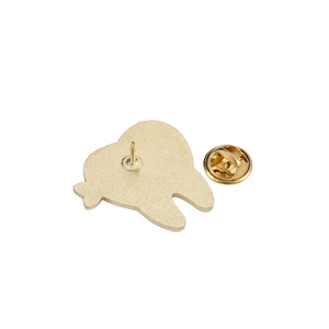 Detail view of the metal enamel pin back with butterfly clutch fastener and golden finish