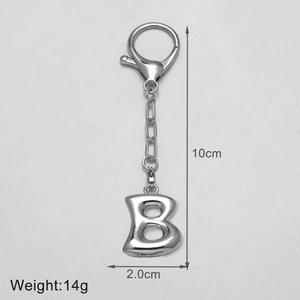 Close-up of a silver letter B keychain showing 10cm height and 2cm width dimensions