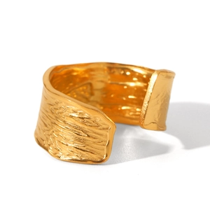Detailed view of wide 18K gold plated ring with hand hammered irregular texture surface