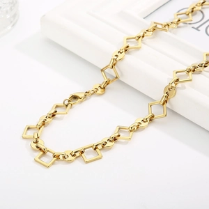 Detailed shot of golden square and circular link chain with secure lobster clasp closure