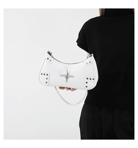 Detail of white PU leather shoulder bag featuring silver star hardware and side metal studs