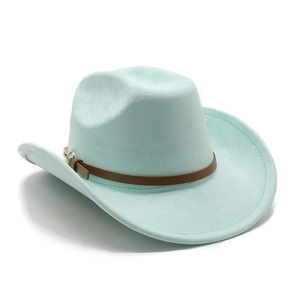 Close-up of mint green felt cowboy hat featuring a brown leather band and golden heart buckle