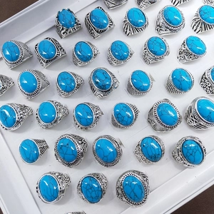 Collection of retro turquoise rings with antique silver finish in a jewelry display box