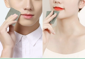 Male and female models using linen facial oil absorbing tissues on their cheeks and chin