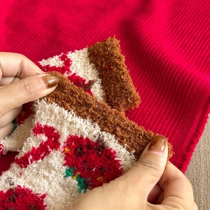 Close-up of thick thermal coral fleece socks with strawberry patterns and plush lining