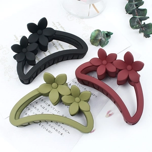 Frosted floral hair claws in black, red, and olive green with semi-circular hollow design