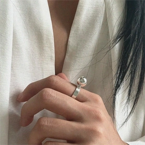 Detailed view of a minimalist 925 sterling silver ring with a large polished metal bead