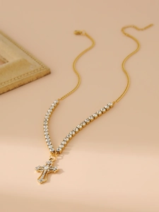 Macro view of gold cross pendant necklace featuring brilliant pavé-set rhinestones