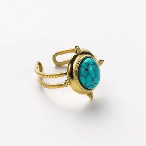 Detail of vintage gold ring with oval turquoise stone and dual-row open band design