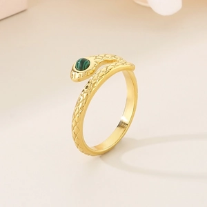 Detail of golden snake ring with green malachite stone and textured scale patterns