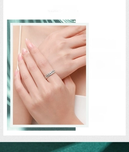 Detailed view of 925 sterling silver leaf ring with braided texture on green silk