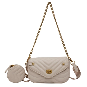 Detail of beige V-quilted leather crossbody bag with gold lock and mini round coin purse