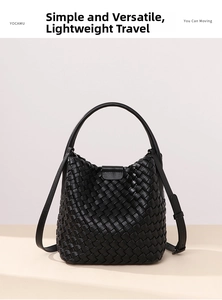 Macro detail of hand-woven black bucket bag with adjustable leather strap and top handle