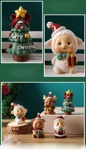 Detail of hand-painted resin Christmas figurines including Santa and reindeer miniatures