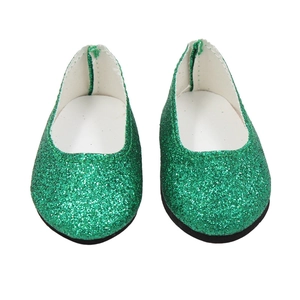 Close-up of green sequin doll flat shoes for 18-inch dolls on a white background