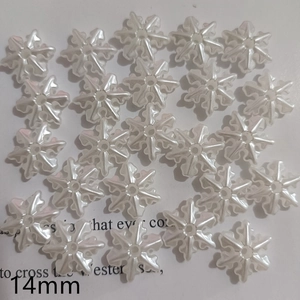 Macro view of 14mm snowflake-shaped faux pearl beads with a pearlescent resin finish