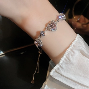 Close-up of pink heart zircon bracelet with adjustable sliding clasp on female wrist