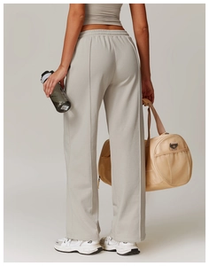 Back view showing high-waisted loose sweatpants with vertical seam detail for women