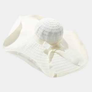 Women's summer wide brim sun hat in beige with decorative ribbon bow and wavy edge