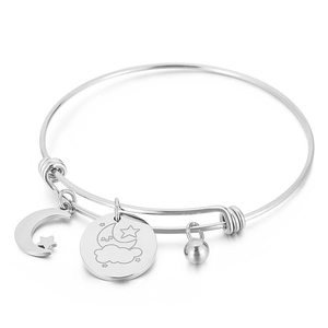 Adjustable silver stainless steel bangle with moon, star, and cloud charms on white background