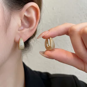 Elegant gold U-shaped huggie earrings with shimmering pave zircon stones for women