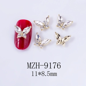 Detailed view of 11x8.5mm gold butterfly nail charms with marquise rhinestones on red nails