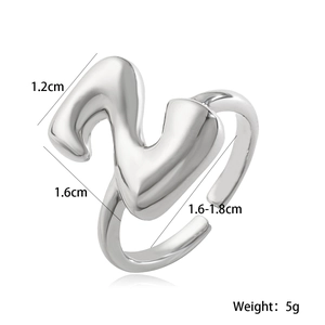 Silver metal ring with abstract wave design and dimensions showing 1.2cm width and 5g weight