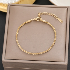 Detail of 18k gold chain bracelet with lobster clasp on luxury jewelry display box