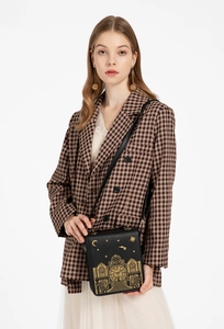Detailed back view of vintage clock-shaped crossbody bag with gold star and moon embroidery