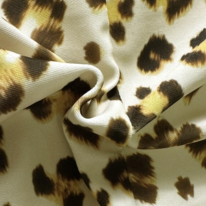 Macro shot of soft leopard print swimwear fabric with detailed leopard pattern texture