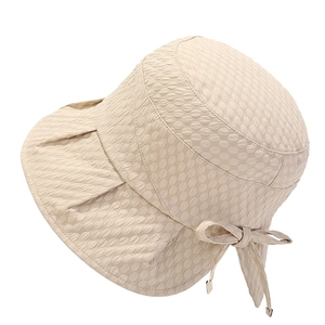 Beige wide brim sun hat with bubble texture and bow detail for summer sun protection