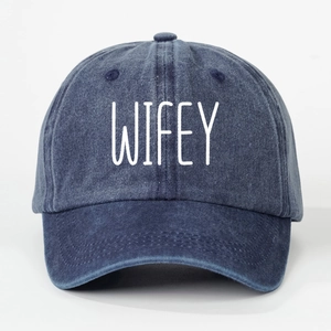 Detailed view of dark blue washed denim baseball cap with white WIFEY embroidery