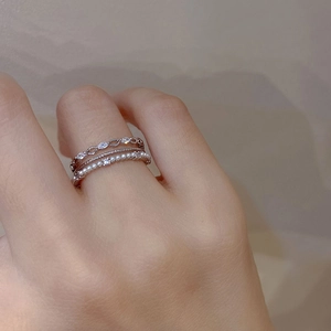 Close-up of stacked silver rings with pearls and sparkling marquise cubic zirconia stones