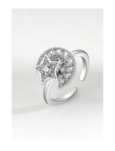 Close-up of rotatable silver ring with moon and star design featuring zircon stones
