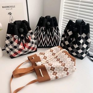 Knitted drawstring bucket bag with geometric patterns and durable woven straps