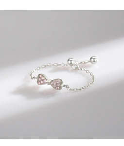 Macro shot of 925 sterling silver bow ring with pink zircon and adjustable chain link