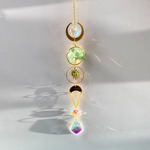 Macro detail of Tree of Life suncatcher with green crystals and rainbow light prisms