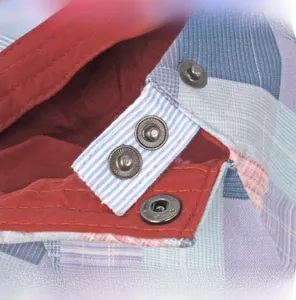 Detailed close-up of the adjustable stainless steel buckle on the colorful checkered cap