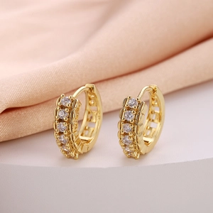 Detailed close-up of gold plated hoop earrings with vertical cubic zirconia inlay setting