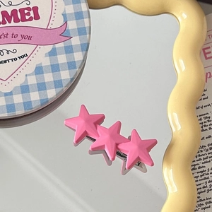 Close-up of pink star hair clips in matte resin with silver metal clasp in Y2K style