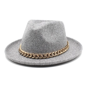 Detail of grey wool fedora hat featuring a chunky gold metal chain decorative band