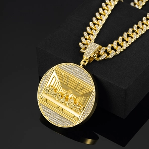 Close-up of gold Cuban chain necklace with iced-out Last Supper circular pendant
