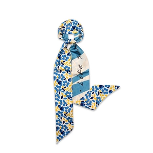 Detail of floral silk scarf with Like SUN text print on white background
