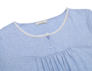 Detail of round neck with white lace trim, transparent buttons and pleats on blue loungewear