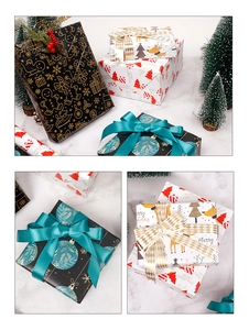 Detail of Christmas wrapping paper rolls with festive gingerbread and reindeer patterns