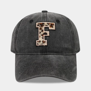 Detailed close-up of leopard print letter F embroidery on vintage washed cotton baseball cap