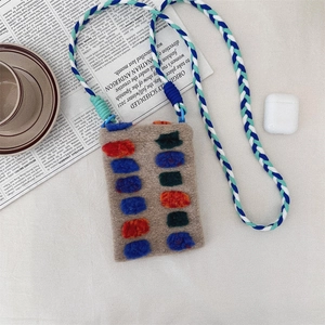 Detail of plush gray mobile phone bag with colorful dots and braided shoulder strap